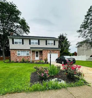 a house with a car parked in the driveway at The Soft Landing Elle's Home Near NYC in Trenton