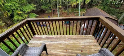 a wooden table and two chairs on a deck at Getaway at the Hideout in Lake Ariel