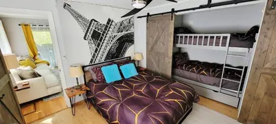 a bedroom with a large bed and a crib at Getaway at the Hideout in Lake Ariel