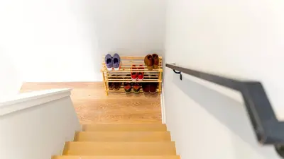 a stairwell with a staircase with shoes in a room at Elegant Urban Escape - 2 Bedrooms, 1 king Bed and 1 Queen Bed, Gated Private Entrance and Parking in Philadelphia
