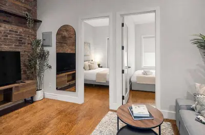a living room with a couch and a mirror at Stylish Retreat in Prime West Village Spot in New York