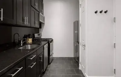 a kitchen with a sink and a stove at Stylish Retreat in Prime West Village Spot in New York