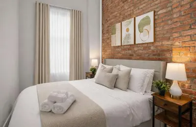 a bedroom with a large bed with towels on it at Stylish Retreat in Prime West Village Spot in New York