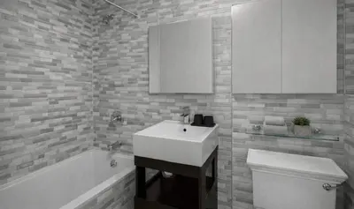 a bathroom with a sink and a toilet and a tub at Stylish Retreat in Prime West Village Spot in New York