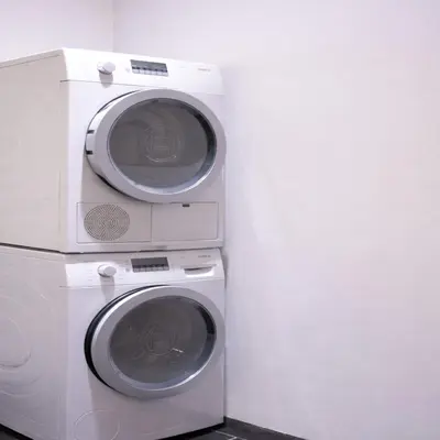 two washing machines sitting next to a wall at Stylish Retreat in Prime West Village Spot in New York