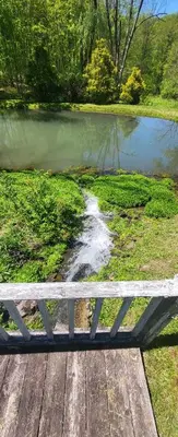 a bench sitting next to a body of water at Susquehanna Waterfall Haven in Susquehanna