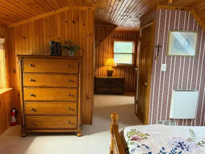 a bedroom with a bed and a dresser in a room at Susquehanna Waterfall Haven in Susquehanna