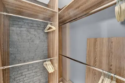 a bathroom with a stone wall and a shower at Modern West Village 1BR Garden steps to subway in New York