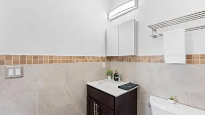 a bathroom with a sink and a toilet and a tub at Luxury Retreat Walk 2 PATH NYC in Mins Parking in Jersey City