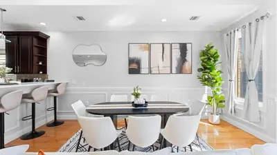 a kitchen and dining room with a table and chairs at Luxury Retreat Walk 2 PATH NYC in Mins Parking in Jersey City