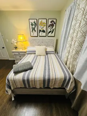a bedroom with a bed with a striped blanket at The Trenton Two 2BR Peaceful Oasis with Patio - Shared Home in Trenton