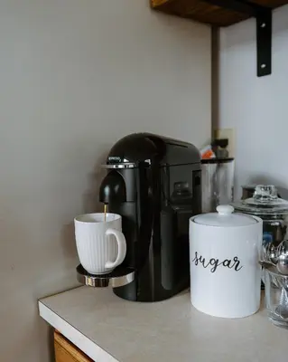 a coffee maker sitting on a counter with a cup at Luxurious Cabin by Lakes & Ski in Lake Ariel