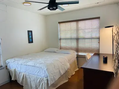a bedroom with a bed and a desk and a window at Aum Quite Heaven Stay in Monroe Township