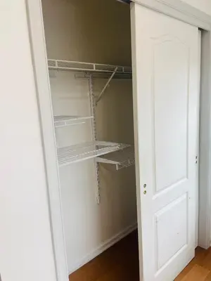 a closet with empty shelves and a door at Aum Quite Heaven Stay in Monroe Township