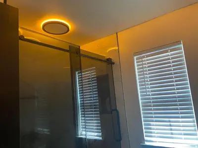 a bathroom with a shower with a window and a mirror at Aum Quite Heaven Stay in Monroe Township