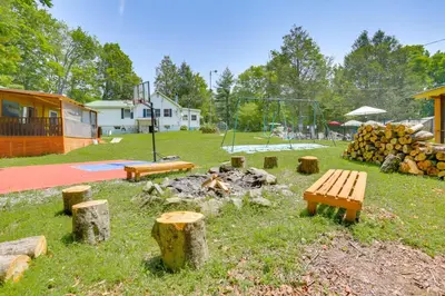 a park with a fire pit and benches and a playground at Screened Porch and Fire Pit Cabin Near Bethel Woods in Mongaup Valley