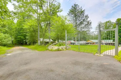 a gate to a driveway with a yard at Screened Porch and Fire Pit Cabin Near Bethel Woods in Mongaup Valley