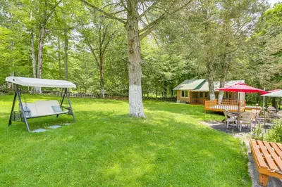 a yard with a picnic table and a tent at Community Perks Mongaup Valley Cabin with Grill! in Mongaup Valley