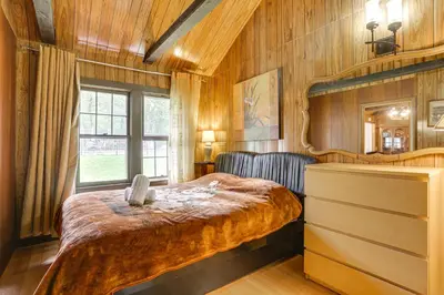 a bedroom with a bed and a chair in it at Community Perks Mongaup Valley Cabin with Grill! in Mongaup Valley