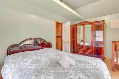 a bedroom with a bed with two pillows on it at 5 Mi to Swinging Bridge Reservoir Cabin with Porch! in Mongaup Valley