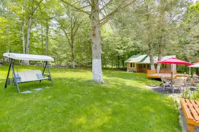 a yard with a picnic table and a tent at 5 Mi to Swinging Bridge Reservoir Cabin with Porch! in Mongaup Valley