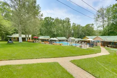a large yard with a pool and some buildings at 5 Mi to Swinging Bridge Reservoir Cabin with Porch! in Mongaup Valley