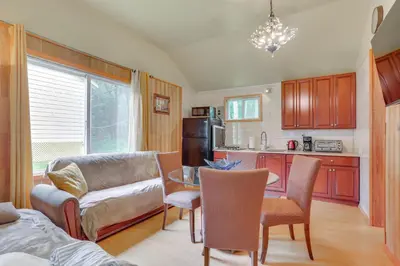 a living room with a couch and a table at 5 Mi to Swinging Bridge Reservoir Cabin with Porch! in Mongaup Valley