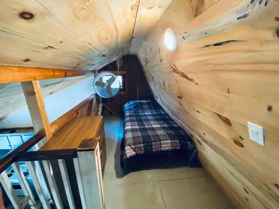 a small room with a bench in a wooden cabin at UndertheWillows by Towanda Sayre in Ulster