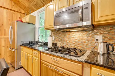 a kitchen with a stove and a microwave at 5 Mi to Monticello Raceway Cabin Near Shops in Mongaup Valley