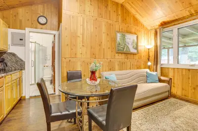 a living room with a table and a couch at 5 Mi to Monticello Raceway Cabin Near Shops in Mongaup Valley