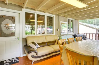 a living room with a couch and a table at 5 Mi to Monticello Raceway Cabin Near Shops in Mongaup Valley