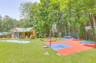 a playground with a basketball hoop in a yard at 5 Mi to Marina and Raceways Mongaup Valley Retreat! in Mongaup Valley