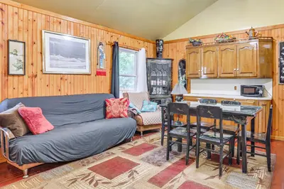a living room with a couch and a table at 5 Mi to Marina and Raceways Mongaup Valley Retreat! in Mongaup Valley