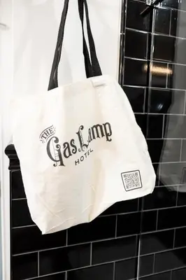 a tote bag hanging in a bathroom at The Gas Lamp Hotel in Philadelphia