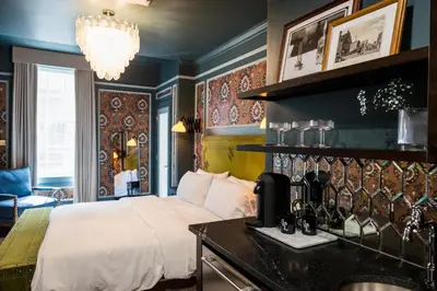 a bedroom with a bed and a table with a blender at The Gas Lamp Hotel in Philadelphia