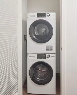 a stack of three washing machines in a room at Luxury Apartments by Hyatus at Central Philly in Philadelphia