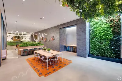 a dining room with a large green wall at Luxury Apartments by Hyatus at Central Philly in Philadelphia