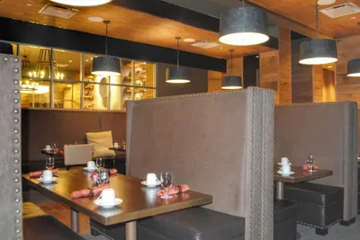 a dining room with tables and chairs and lights at DoubleTree by Hilton Hotel Reading in Reading