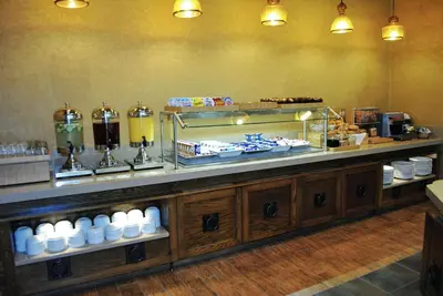 a buffet line in a restaurant with food on display at DoubleTree by Hilton Hotel Reading in Reading