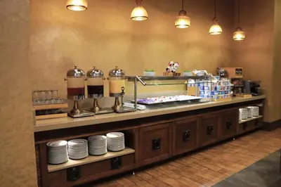 a restaurant with a counter with plates on it at DoubleTree by Hilton Hotel Reading in Reading