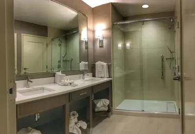a bathroom with a sink and a shower and a mirror at DoubleTree by Hilton Hotel Reading in Reading