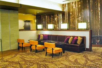 a lobby with a couch and a table and chairs at DoubleTree by Hilton Hotel Reading in Reading