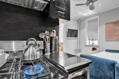 a kitchen with a stove with a tea kettle on it at Modern 3BR in Gramercy -Near Union Sq NYU in New York