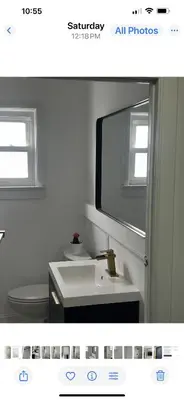 a bathroom with a sink and a toilet and a mirror at Sava apt rentals in Newark