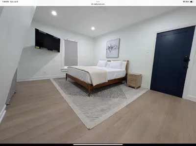 a bedroom with a bed and a flat screen tv at Sava apt rentals in Newark