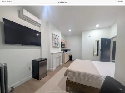 a bedroom with a bed and a flat screen tv at Sava apt rentals in Newark