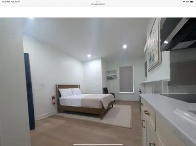 a bedroom with a bed and a kitchen with a sink at Sava apt rentals in Newark