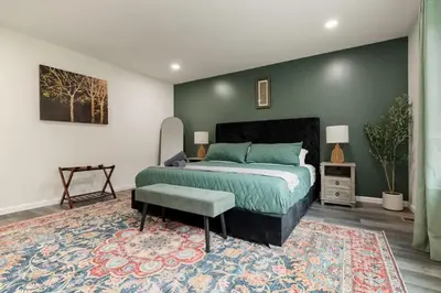 a bedroom with a king sized bed and a rug at Upstate NY Escape - Game Ready, Game Room, Pool Table, Firepit, Delaware River in Sparrow Bush