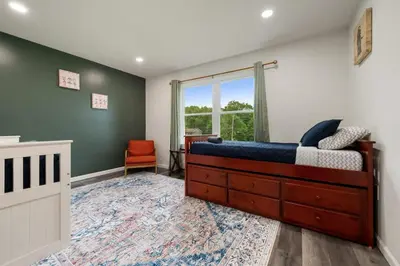 a bedroom with a bed and a large window at Upstate NY Escape - Game Ready, Game Room, Pool Table, Firepit, Delaware River in Sparrow Bush