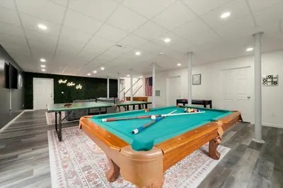 a pool table in a room with two tables at Upstate NY Escape - Game Ready, Game Room, Pool Table, Firepit, Delaware River in Sparrow Bush